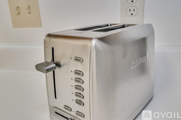 A Cuisinart toaster is on a white surface.