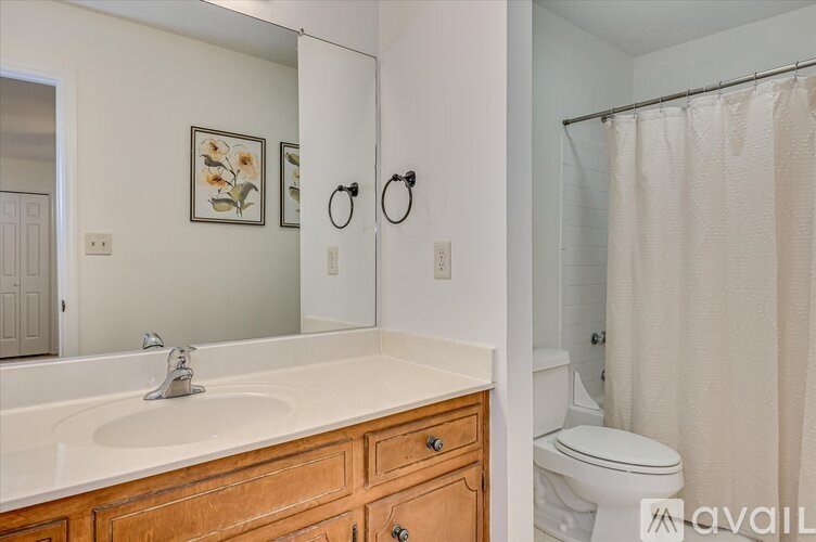 A bathroom with a white sink and toilet.