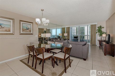 A living room with a dining table and chairs.