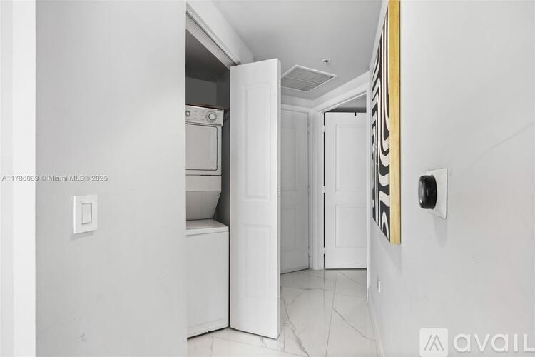 A white kitchen with a stove top oven and a white fridge.