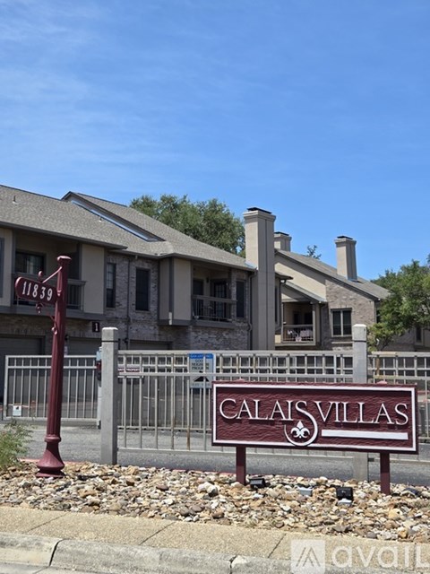 A sign for Calais Villas in front of a house.