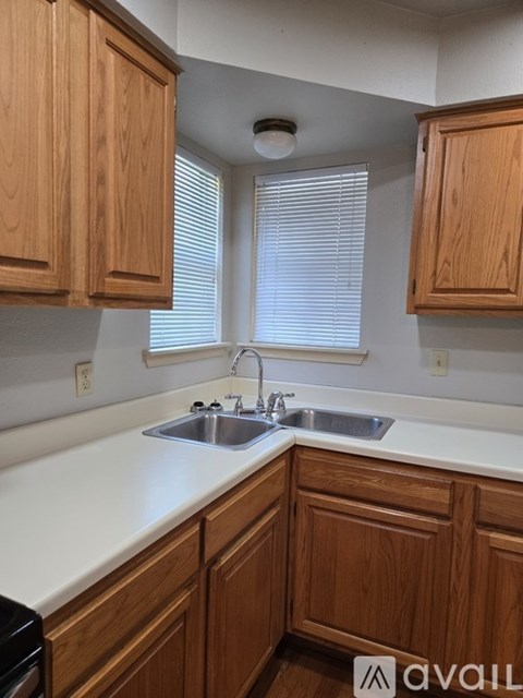 A kitchen with wooden cabinets and a white countertop.
