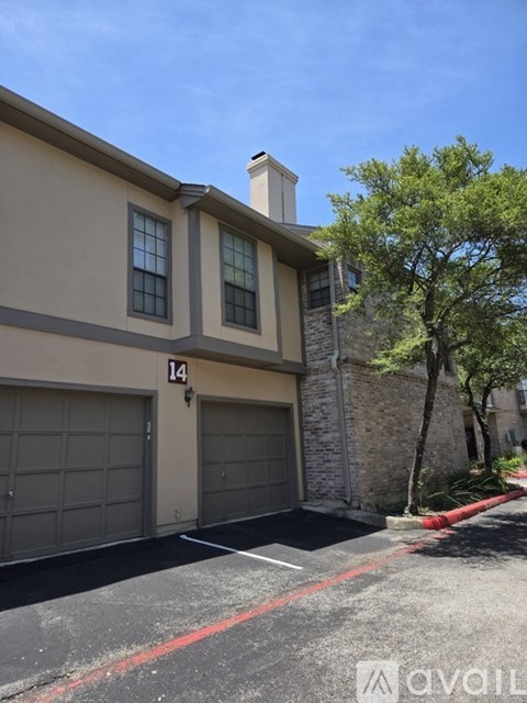 A two-story house with a garage and number 14 on the front.