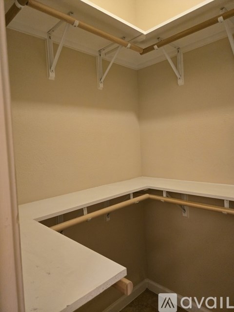 A room with a white counter and brown walls.