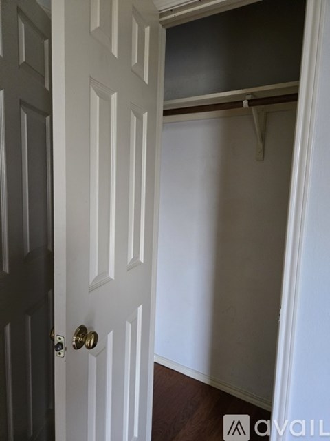 A white door with a black door on the left and a white wall behind it.