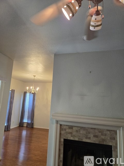 A room with a fireplace and a chandelier.