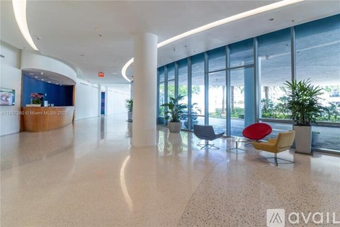 A spacious lobby with a reception desk and seating area.