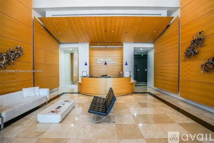 A reception area with a white sofa, a black bench, and a wooden counter.