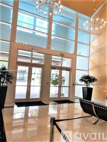 A large glass door with a black mat in front of it.