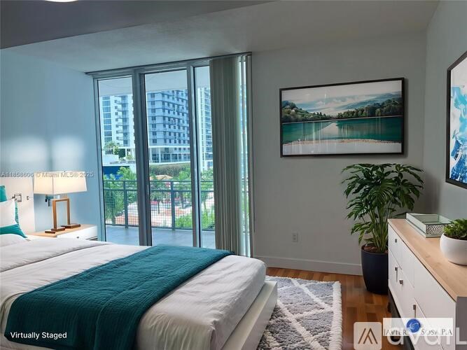A bedroom with a large bed and a painting on the wall.