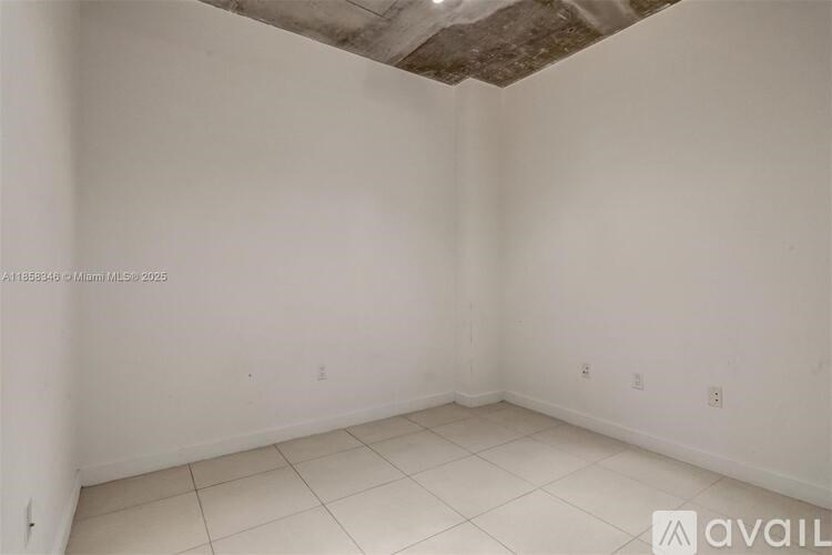 A room with white walls and a white ceiling with a light fixture.