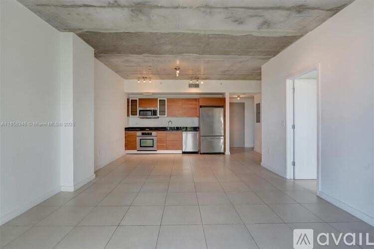 A kitchen area with a refrigerator, oven, and microwave.
