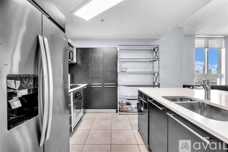 A modern kitchen with stainless steel appliances and a large island.