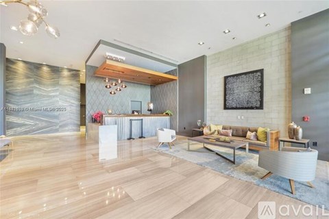 A modern living room with a wooden floor and a large painting on the wall.