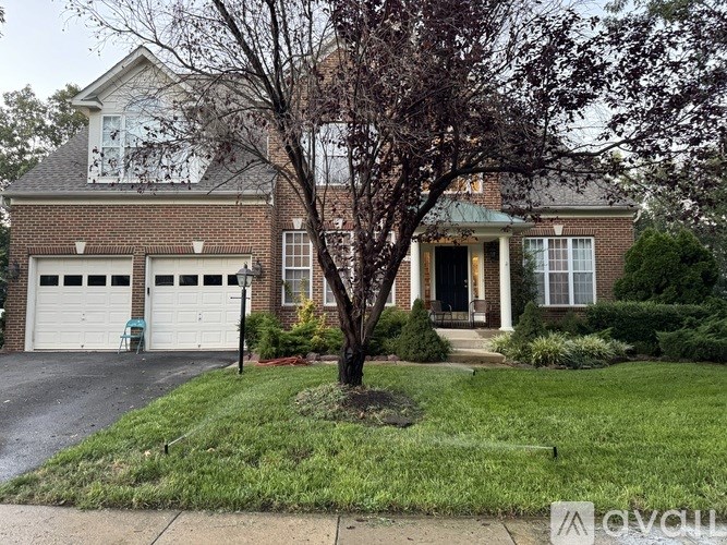 A house with a tree in front of it.