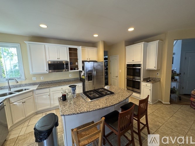 A living room with a couch, television, and a bed.