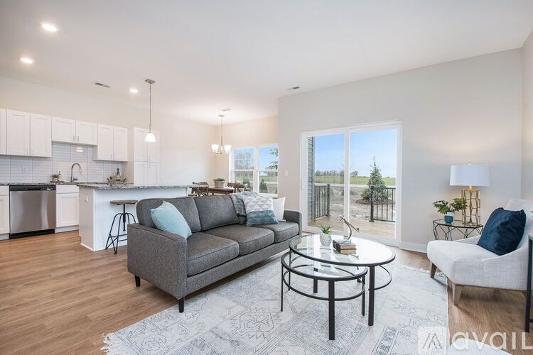A modern living room with a grey sofa and a glass table.