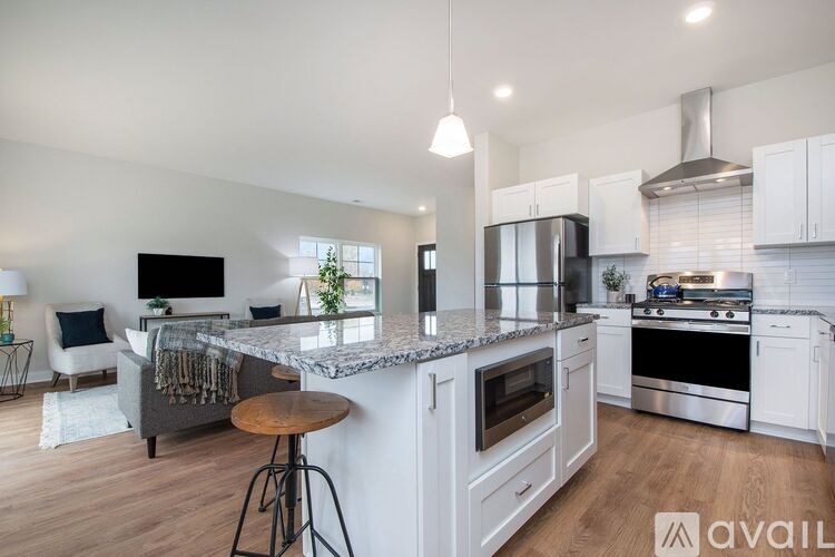 A modern kitchen with a bar stool and a countertop.
