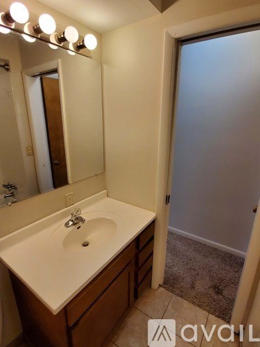 A bathroom with a sink and mirror.