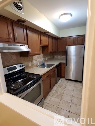 A kitchen with a stove, oven, and refrigerator.