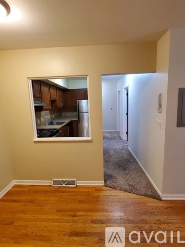 A room with wooden floors and a mirror on the wall.