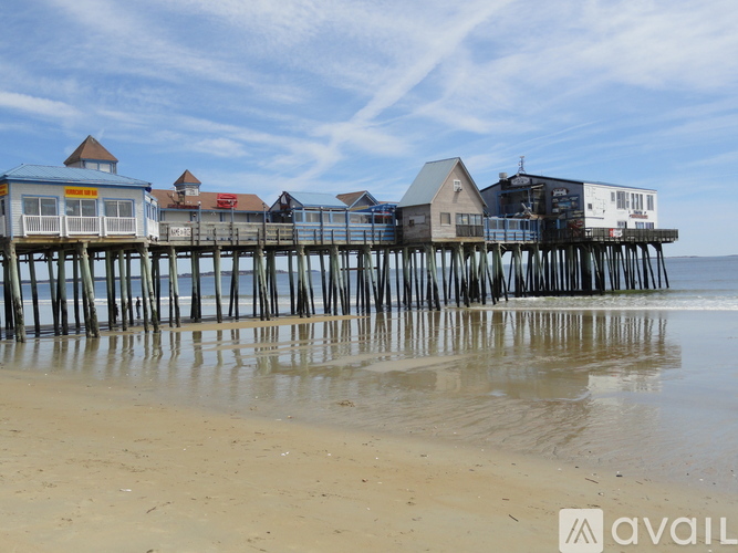 A long pier with several buildings on it extends into the water.