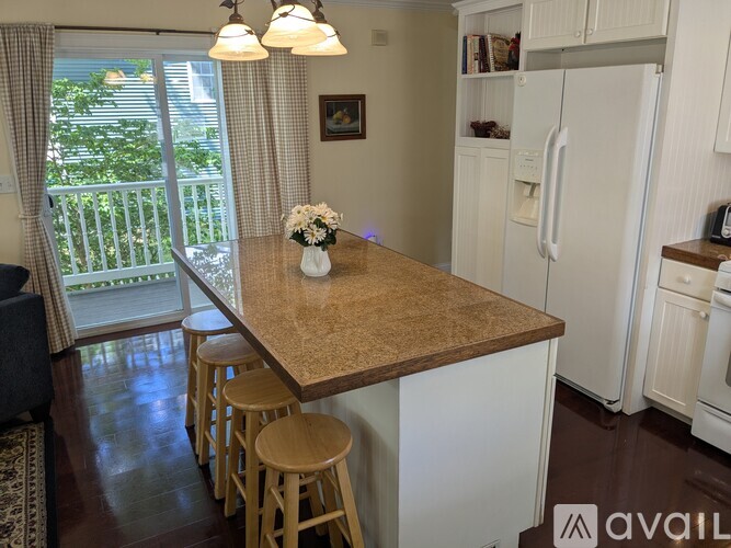 A kitchen with a table and chairs in front of a window.