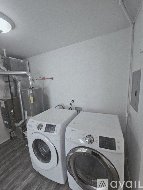 Two front load washing machines in a laundry room.