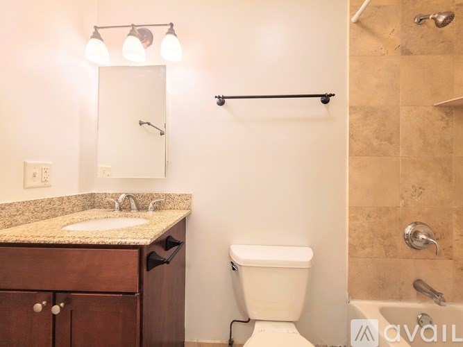 A bathroom with a sink, toilet, and a shower.