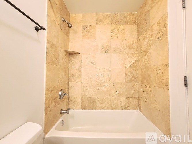 A bathroom with a tiled shower and a bathtub.