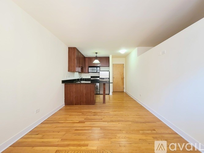 A kitchen with wooden floors and white walls.