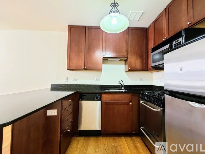 A kitchen with wooden cabinets and stainless steel appliances.