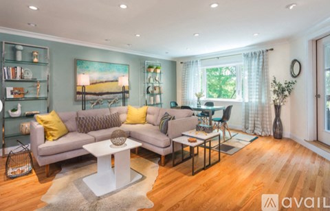 A living room with a grey sofa and a white coffee table.