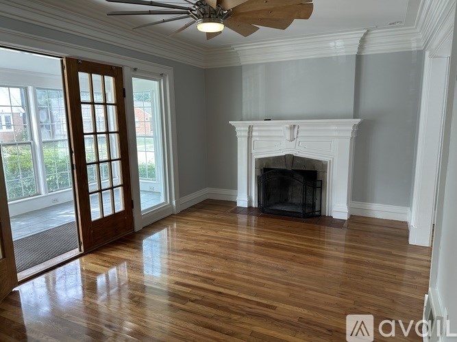 A room with a fireplace and a ceiling fan.