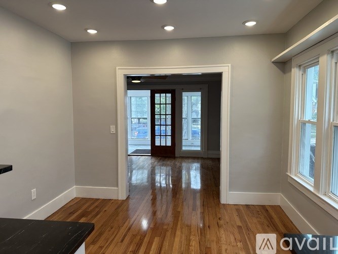 A room with wooden floors and a black countertop.