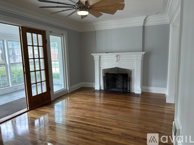 A room with a fireplace and a ceiling fan.