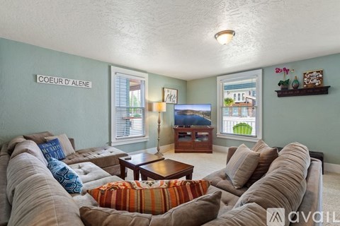A living room with a large couch and a coffee table.
