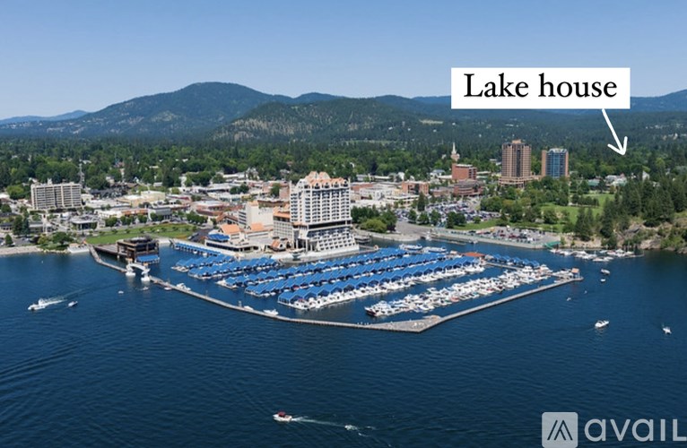 A large marina with a lake house in the background.