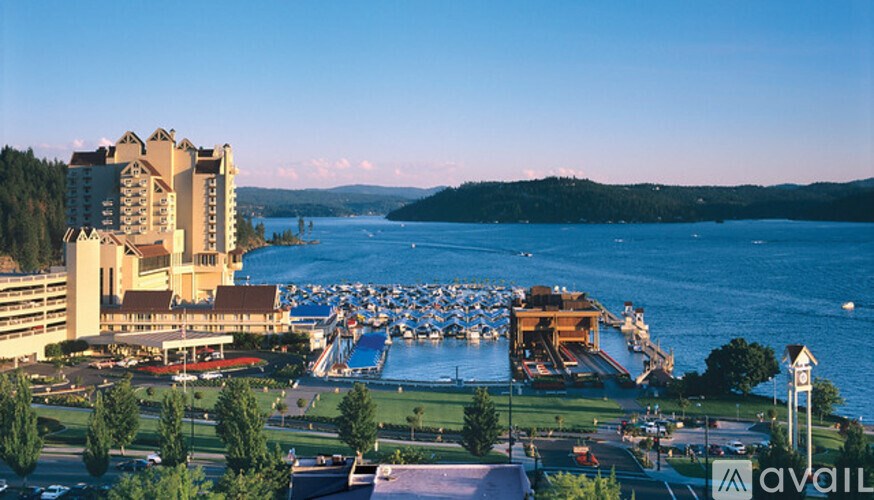 A large hotel with a body of water in front of it.