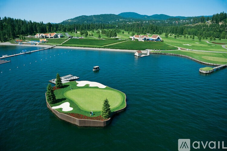 A golf course is surrounded by water and has a green island with a hole in the middle.
