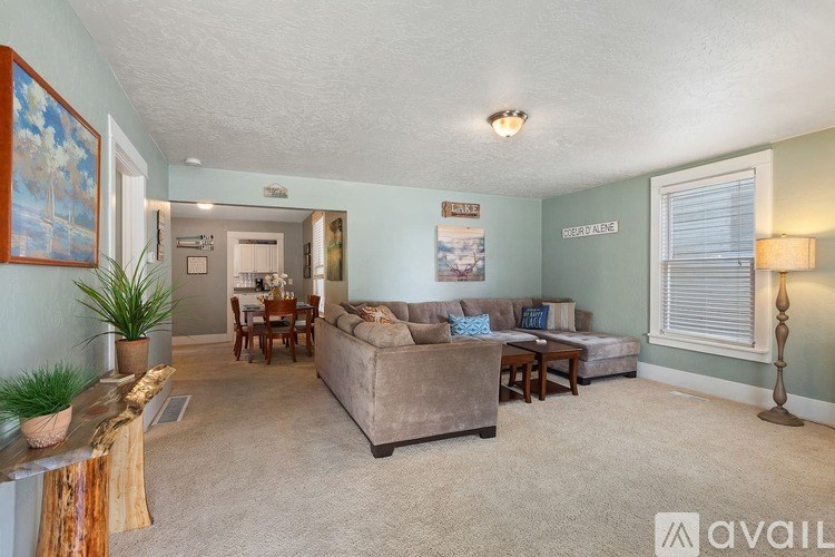A living room with a couch, a chair, a table, and a lamp.