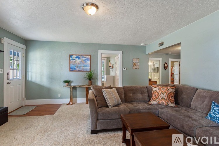 A living room with a grey couch and a small table.