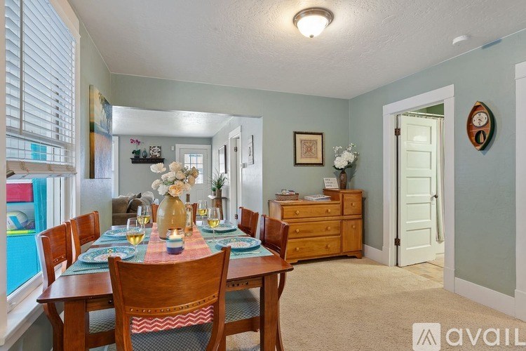 A dining room with a table set for a meal.