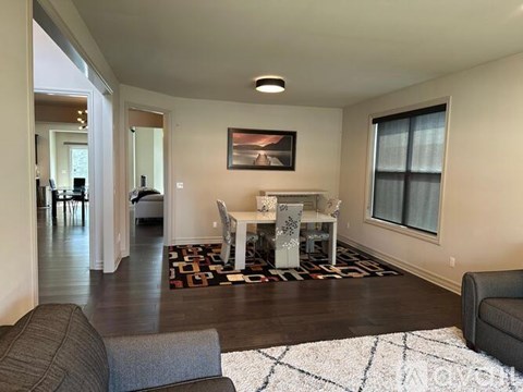 A living room with a grey couch and a white coffee table.