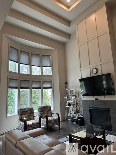 A living room with a fireplace and a television.