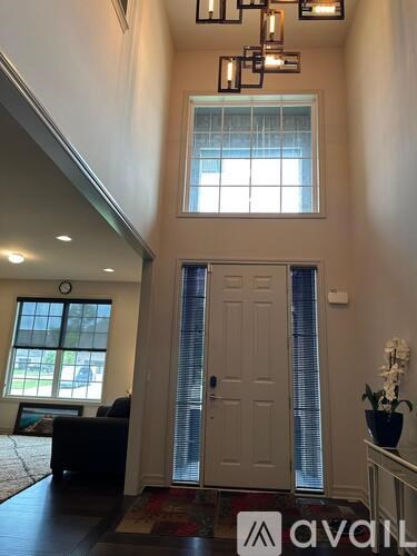 A hallway with a door and a window.