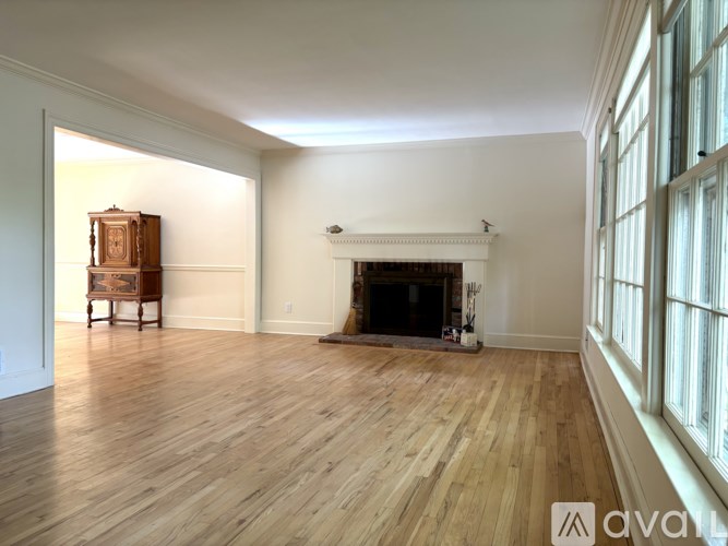 A room with a fireplace and wooden floors.