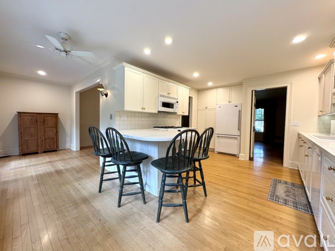 A kitchen with a table and chairs in the middle of the room.