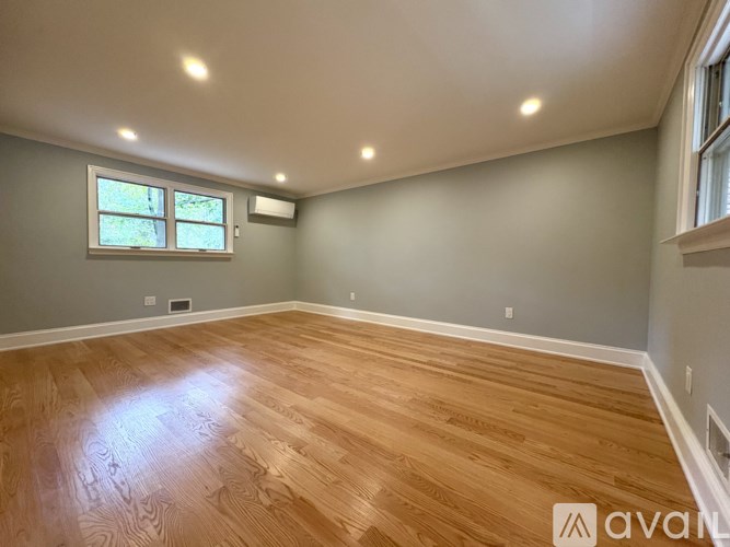 A room with wooden flooring and a window.
