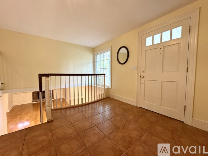 A room with a brown floor and a white door.